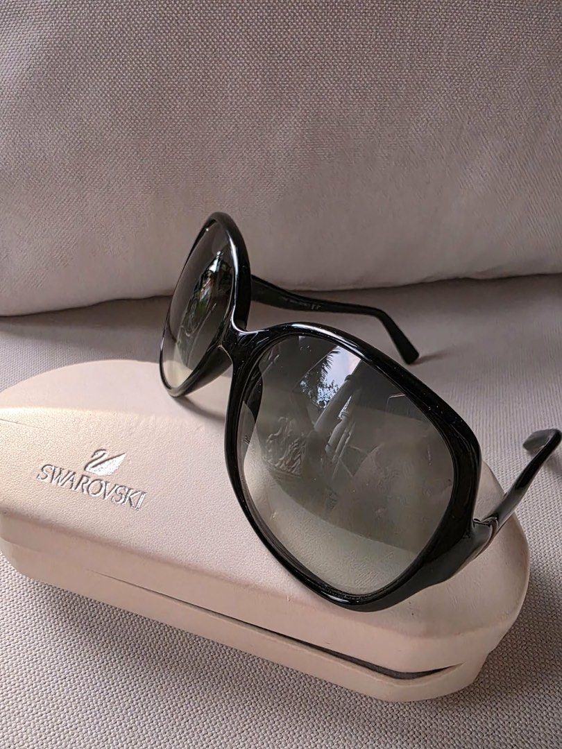 Swarovski black oversized sunglasses with case (Category: Sunglasses & Eyewear) located in Paranaque City. Submitted by dsthings (Listing ID 1469613045, Image 1). Description: - Brand: Swarovski Asia SW11 - Lenses: Dark gradient lenses with Swan temple accents - Details: Signature silver branding on the temples - Inclusion: Original hard case - Condition: Lightly used.