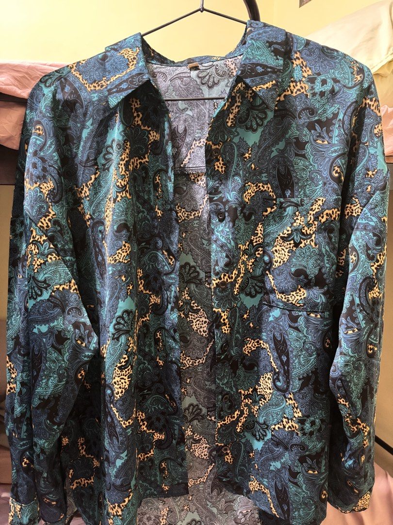 Teal and Blue Paisley Leopard Print Button Down Shirt (Category: Longsleeves) located in Pasig City. Submitted by krystlemoc26502 (Listing ID 1469748947, Image 3). Description: - Vibrant teal and blue paisley and leopard mix print - Classic button-down front with collar and chest pocket - Relaxed, comfortable fit made from lightweight fabric - Versatile styling: looks great tucked into high-waisted trousers or loose over jeans - Condition: Excell