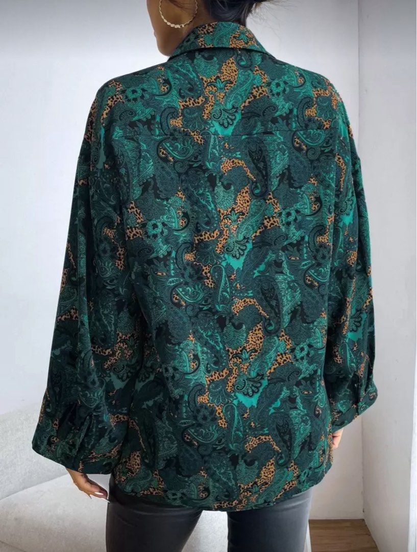 Teal and Blue Paisley Leopard Print Button Down Shirt (Category: Longsleeves) located in Pasig City. Submitted by krystlemoc26502 (Listing ID 1469748947, Image 2). Description: - Vibrant teal and blue paisley and leopard mix print - Classic button-down front with collar and chest pocket - Relaxed, comfortable fit made from lightweight fabric - Versatile styling: looks great tucked into high-waisted trousers or loose over jeans - Condition: Excell