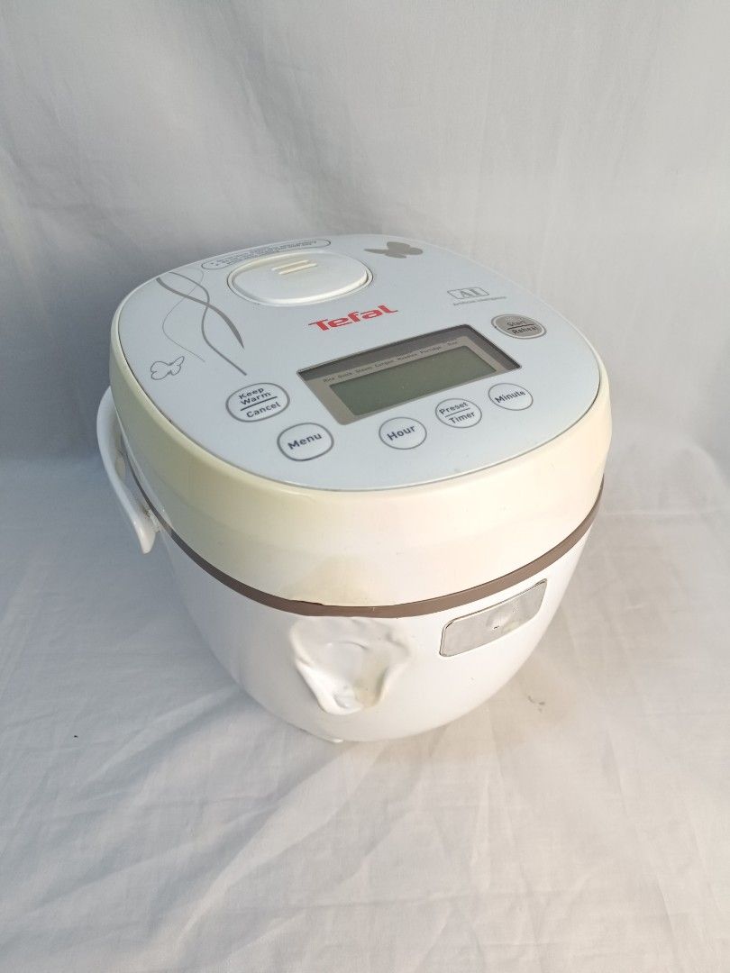 Tefal AI Digital Rice Cooker (Category: Cookers) located in Baguio. Submitted by clothes.over.bros.ph_2020 (Listing ID 1469596227, Image 1). Description: - Brand: Tefal AI Rice Cooker - Display: Digital panel on top with preset timer, keep warm, and menu functions - Capacity: Brown inner pot with measurements up to 4 cups / 3/4 liter - Condition: Clean interior heating element, well-maintained - Inclusions: Power cord (still wrapped in plastic) -