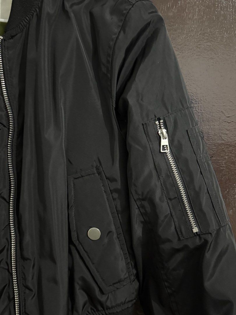 Terranova Black Bomber Jacket Size XS (Category: Coats, Jackets and Outerwear) located in Manila. Submitted by meeyaw23 (Listing ID 1469653998, Image 3). Description: - Brand: Terranova - Color: Black with olive green inner lining - Size: XS - Closure: Zip-up front with silver hardware - Pockets: Front snap-button pockets and sleeve zip pocket - Details: Ribbed collar, cuffs, and hem - Fit: Casual, great layer for cooler weather.