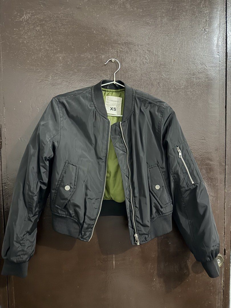 Terranova Black Bomber Jacket Size XS (Category: Coats, Jackets and Outerwear) located in Manila. Submitted by meeyaw23 (Listing ID 1469653998, Image 1). Description: - Brand: Terranova - Color: Black with olive green inner lining - Size: XS - Closure: Zip-up front with silver hardware - Pockets: Front snap-button pockets and sleeve zip pocket - Details: Ribbed collar, cuffs, and hem - Fit: Casual, great layer for cooler weather.