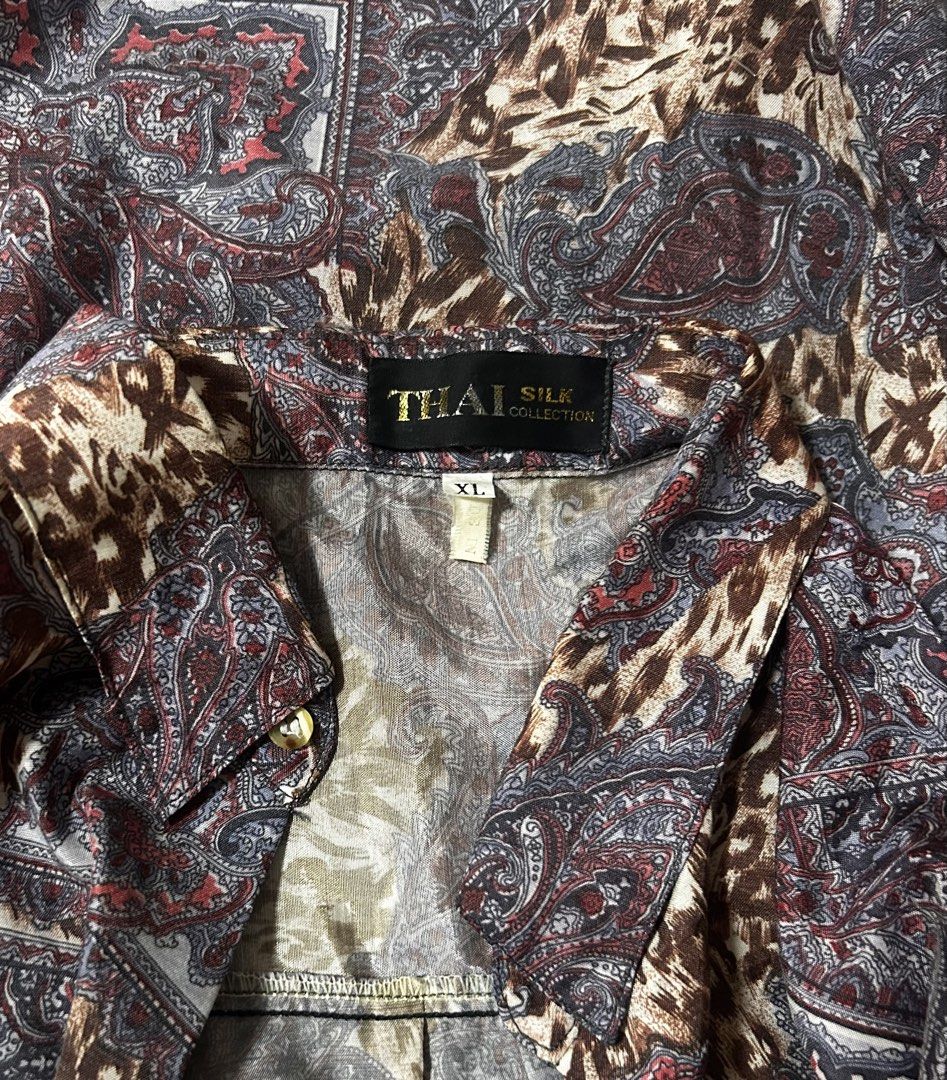THAI SILK (Category: Tshirts & Polo Shirts ) located in Davao. Submitted by sart0ria85 (Listing ID 1469615292, Image 3). Description: - Brand: Thai Silk Collection - Size: XL - Color/Pattern: Brown, grey, and red with bold paisley and animal print - Features: Regular collar, single left chest pocket, lightweight material, MADE IN THAILAND 🇹🇭 XLARGE. Size 12 EXCELLENT CONDITION (92/100).