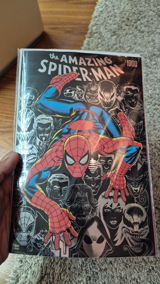 The Amazing Spider-Man 1000 Comic Book (Category: Comics & Manga) located in Muntinlupa City. Submitted by lazoftoys (Listing ID 1469590490, Image 1). Description: - Issue: The Amazing Spider-Man #1000 - Cover Art: Spider-Man in classic red and blue suit against a striking black and white background of classic character faces - Condition: Bagged and boarded for ultimate protection - Ideal For: Wall crawler fans and comic book collectors - Locatio