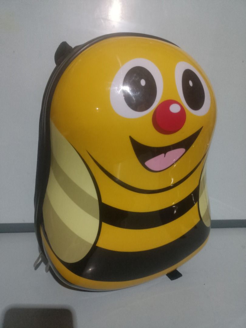 The Cuties and Pals Bee Kids Hard Shell Backpack (Category: Backpacks) located in Munoz. Submitted by larryc1212 (Listing ID 1469683906, Image 1). Description: - Authentic Cuties and Pals bumblebee character backpack - Eye-catching yellow and black hard shell design with a cute cartoon face - Comfortable, adjustable black shoulder straps and sturdy top handle - Secure zip closure to keep belongings safe - Fun branded printed fabric lining inside 