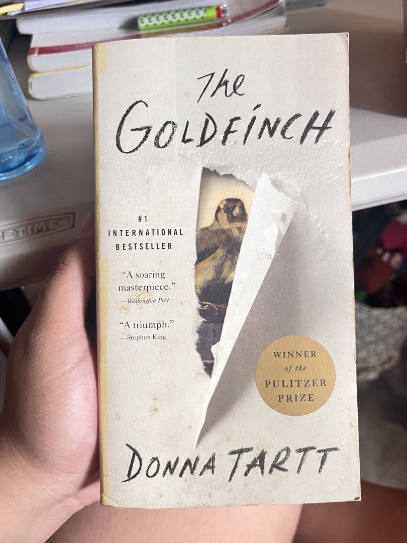 The Goldfinch by Donna Tartt (Category: Storybooks) located in Quezon City. Submitted by ellalalaaa (Listing ID 1469602285, Image 1). Description: - Title: The Goldfinch by Donna Tartt - Accolades: Pulitzer Prize Winner & International Bestseller - Condition: Heavy wear on the cover with a major tear (revealing the bird artwork underneath); all pages are fully intact and readable - Perfect for: Fiction fans looking for a great read on a budget.