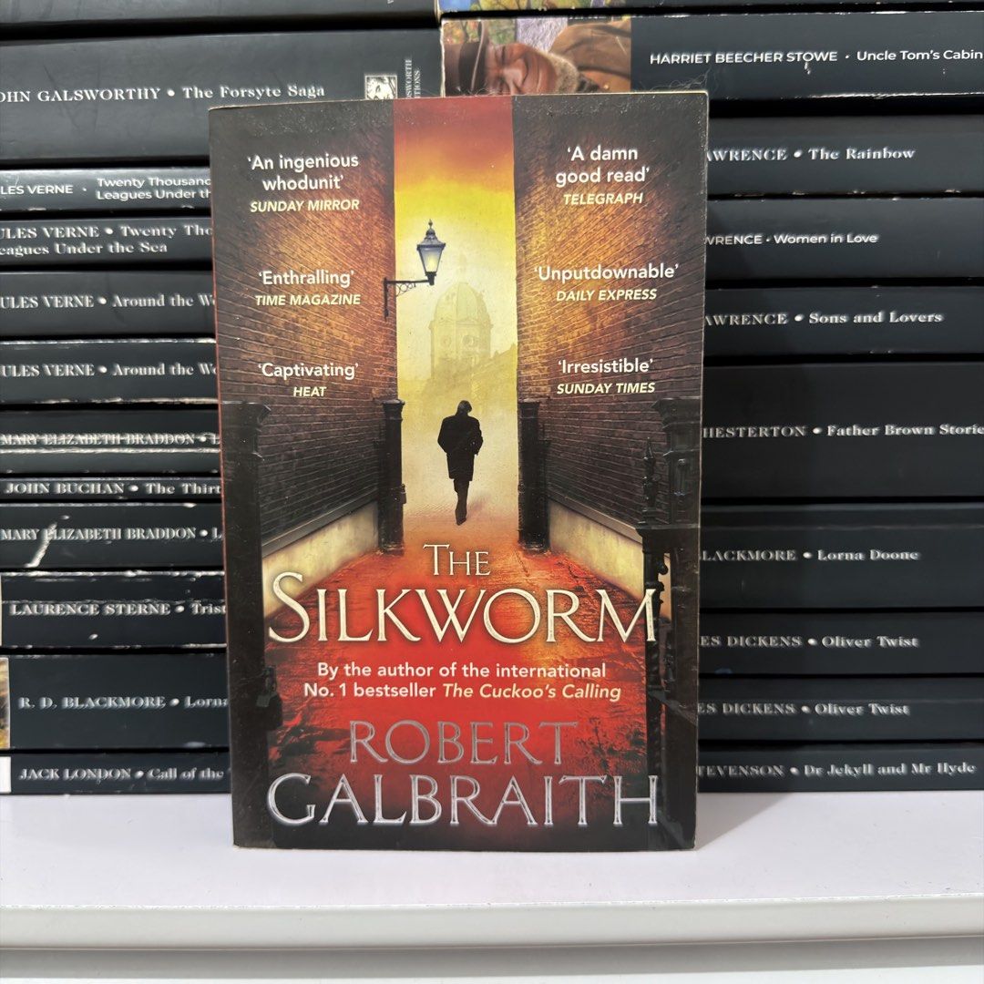 The Silkworm by Robert Galbraith Novel (Category: Storybooks) located in Lingayen. Submitted by readwjane (Listing ID 1469591530, Image 1). Description: - Title: The Silkworm - Author: Robert Galbraith (J.K. Rowling) - Format: Paperback with striking alleyway cover art - Highlights: Includes critical praise quotes printed on the front cover - Genre: Detective fiction / Mystery novel - Condition: Great read for fans of thrilling mystery stories.