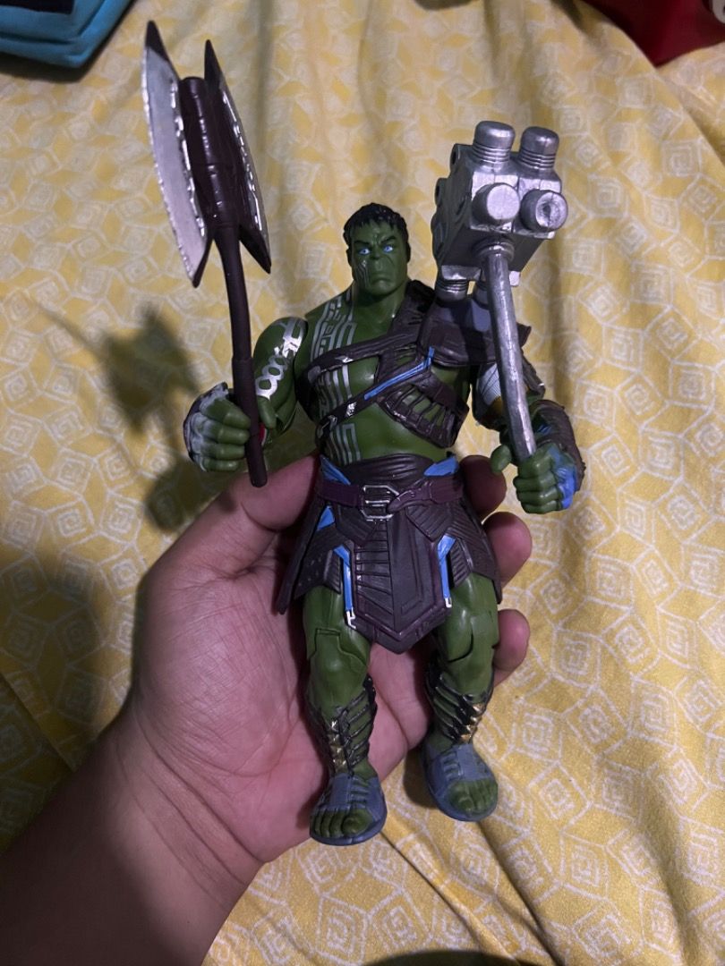 Thor Ragnarok Gladiator Hulk Action Figure with Weapons (Category: Figurines & Statues) located in Caloocan City. Submitted by mherckyyragkee (Listing ID 1469675643, Image 1). Description: - Character: Gladiator Hulk from Thor: Ragnarok - Size: Stands approx. 7 inches tall - Accessories: Includes battle axe and hammer weapons - Details: Features intricate armor plating, shoulder guard, and gladiator sandals - Articulation: Fully articulated joint
