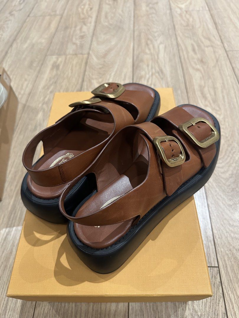 Tod's Leather Buckle Sandals (Category: Flats & Sandals) located in Caloocan City. Submitted by nicsching (Listing ID 1469679992, Image 3). Description: - Brand: Tod's - Style: Two-strap platform sandals with slingback - Color: Brown leather with large gold-tone buckles and thick black soles - Condition: Excellent, premium craftsmanship - Inclusions: Original branded dust bag and orange presentation box - Perfect for: Warm weather, casual outings