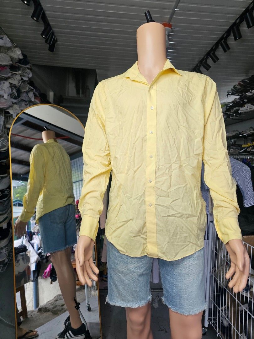 Tommy Hilfiger yellow polo (Category: Formal Shirts) located in Baguio. Submitted by kayeonlineshop (Listing ID 1469662612, Image 1). Description: pale yellow, long-sleeve button-down dress shirt with a spread collar and barrel cuffs..