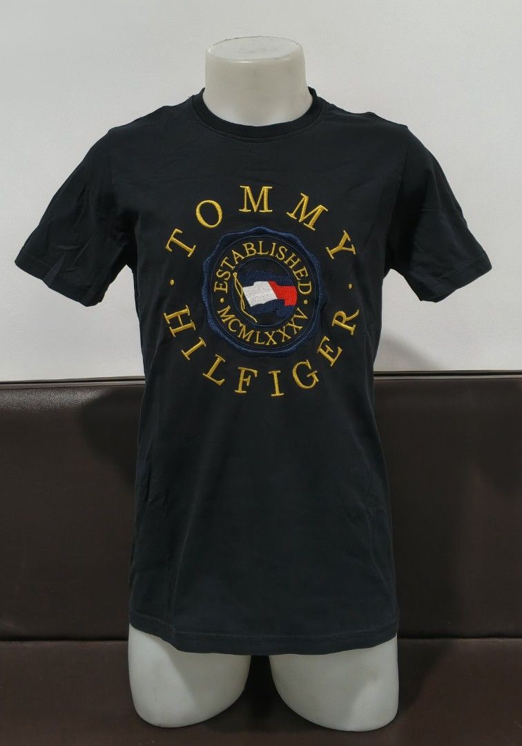 Tommy H!lfiger Icon Logo (Category: Tshirts & Polo Shirts ) located in Kabacan. Submitted by thriftedsupremacy11 (Listing ID 1469733391, Image 1). Description: TOMMY HILFIG3R ICON LOGO EMBROIDERED M-L Dimes 27.5 x 19 Like new condition Issue: none.