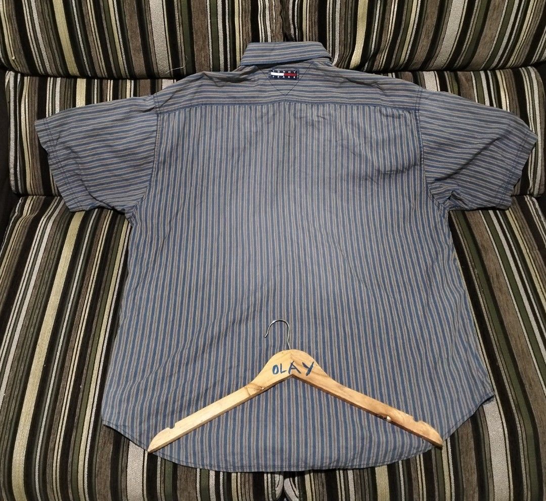 Tommy Jeans Button Down Striped Shirt (Category: Tshirts & Polo Shirts ) located in Taguig. Submitted by conniemdcruz (Listing ID 1469707237, Image 2). Description: - Brand: Tommy Jeans - Style: Short sleeve button-down shirt - Design: Blue base with fine vertical stripes and small chest pocket logo flag - Fit: Relaxed fit - Material: Comfortable cotton fabric - Versatility: Classic casual piece, easy to match with jeans or shorts Vintage Tommy L