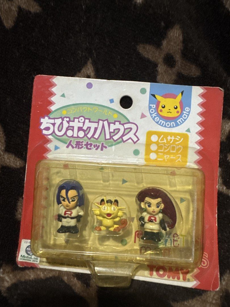 Tomy Pokémon Mate Rocket Team Figure Set (Category: Figurines & Statues) located in Marikina City. Submitted by zobel.yanna (Listing ID 1469576854, Image 1). Description: - Authentic vintage Tomy Pokémon Mate figure set - Features the iconic Team Rocket trio: Jessie, James, and Meowth - Japanese Chibi Poke House doll set packaging - Unopened blister pack (minor shelf wear on cardboard backing) - Rare collectible item for Pokémon fans.