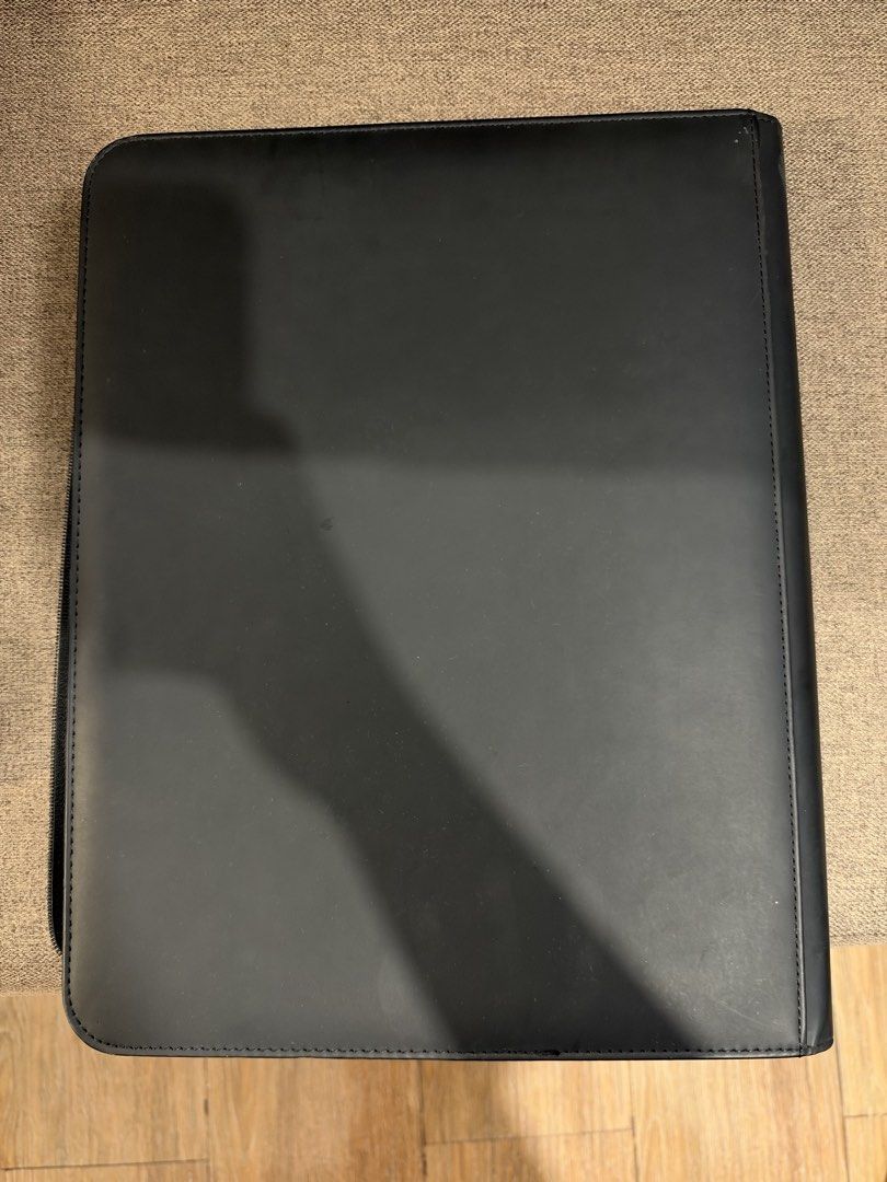 Toploader Black Leather Trading Card Binder Album (Category: Trading Cards Accessories) located in Manila. Submitted by garagesalebykoda (Listing ID 1469574610, Image 2). Description: - Type: Black leather trading card binder - Closure: Full zipper closure for maximum security - Condition: Solid structure with front cover stains from old stickers and scuffs, clean back, and minor spine edge wear - Usability: Fully functional with plenty of life l
