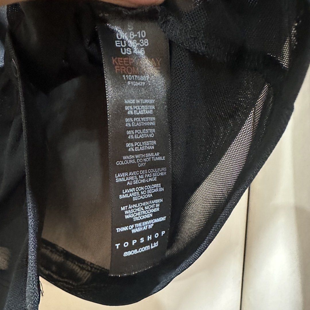 Topshop - Sheet Mesh Ruched Long Sleeve Blouse (Category: Longsleeves) located in Muntinlupa City. Submitted by pickjes (Listing ID 1469718268, Image 3). Description: Brand: Topshop Size: Small Material: 96% polyester, 4% elastane Condition: Brand new, never worn, just stored. No flaws. Rfs: Decluttering, impulse buy Topshop black sheer mesh ruched long-sleeve button-up shirt. It features a classic spread collar, a button placket down the front, 