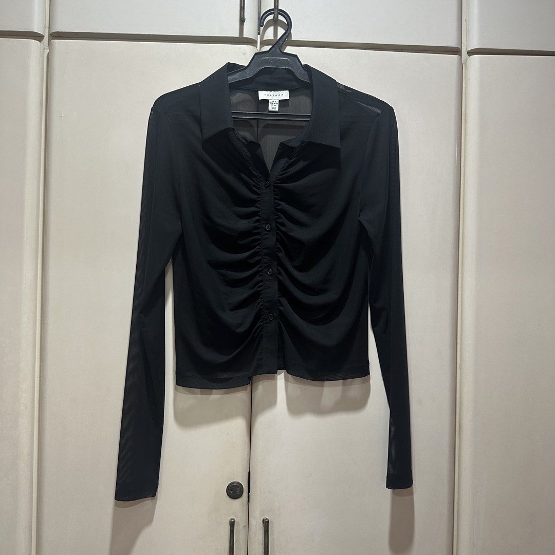 Topshop - Sheet Mesh Ruched Long Sleeve Blouse (Category: Longsleeves) located in Muntinlupa City. Submitted by pickjes (Listing ID 1469718268, Image 1). Description: Brand: Topshop Size: Small Material: 96% polyester, 4% elastane Condition: Brand new, never worn, just stored. No flaws. Rfs: Decluttering, impulse buy Topshop black sheer mesh ruched long-sleeve button-up shirt. It features a classic spread collar, a button placket down the front, 