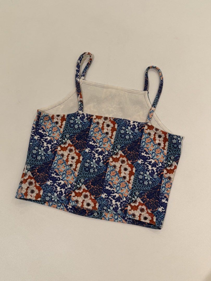 Topshop Blue Floral Patchwork Crop Top UK 10 (Category: Sleeveless) located in Muntinlupa City. Submitted by henlo03 (Listing ID 1469611618, Image 3). Description: - Brand: Topshop - Design: Blue, rust, and white patchwork floral print - Style: Square neckline with thin double straps, short/crop length - Size: UK 10, EUR 38, US 6 - Origin: Made in Turkey - Fabric: Lightweight and comfy - Condition: like new .
