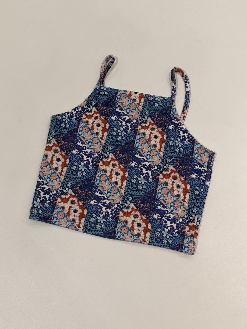 Topshop Blue Floral Patchwork Crop Top UK 10 (Category: Sleeveless) located in Muntinlupa City. Submitted by henlo03 (Listing ID 1469611618, Image 1). Description: - Brand: Topshop - Design: Blue, rust, and white patchwork floral print - Style: Square neckline with thin double straps, short/crop length - Size: UK 10, EUR 38, US 6 - Origin: Made in Turkey - Fabric: Lightweight and comfy - Condition: like new .