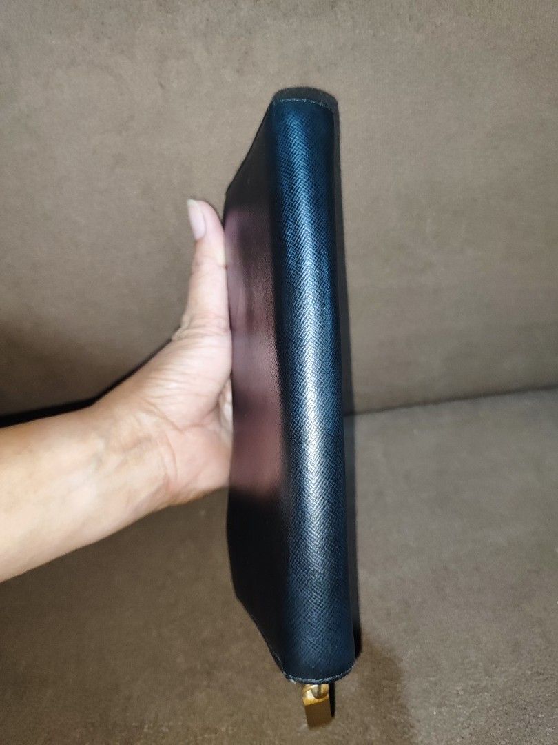 Tory Burch Black Saffiano Leather Zip Around Wallet (Category: Luxury Bags & Wallets) located in Paniqui. Submitted by arlenepari29210 (Listing ID 1469709577, Image 3). Description: - Brand: Tory Burch - Material: Premium black Saffiano leather - Hardware: Elegant gold-tone with iconic front logo emblem - Closure: Smooth zip-around closure - Interior: Multiple card slots, slip compartments, and a central zippered coin pocket - Size: Standard long