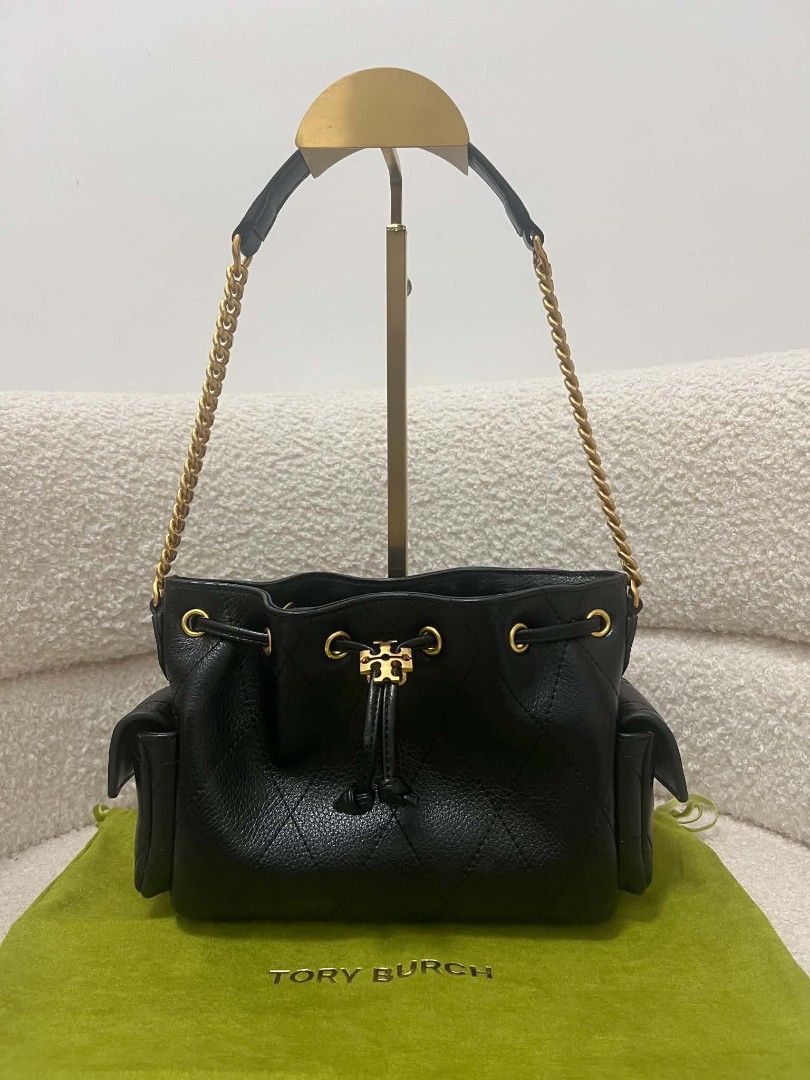 Tory Burch Mini Charlie Drawstring Bag (Category: Shoulder Bags) located in Paoay. Submitted by rvf1230 (Listing ID 1469689344, Image 3). Description: - Brand: Tory Burch - Color: Classic black leather with gold-tone hardware - Design: Quilted diamond pattern on lower half and iconic T logo drawstring closure - Condition: Extremely clean inside and out - Interior: Soft tan suede lining with a secure zippered pocket - Exterior: Handy side pockets 