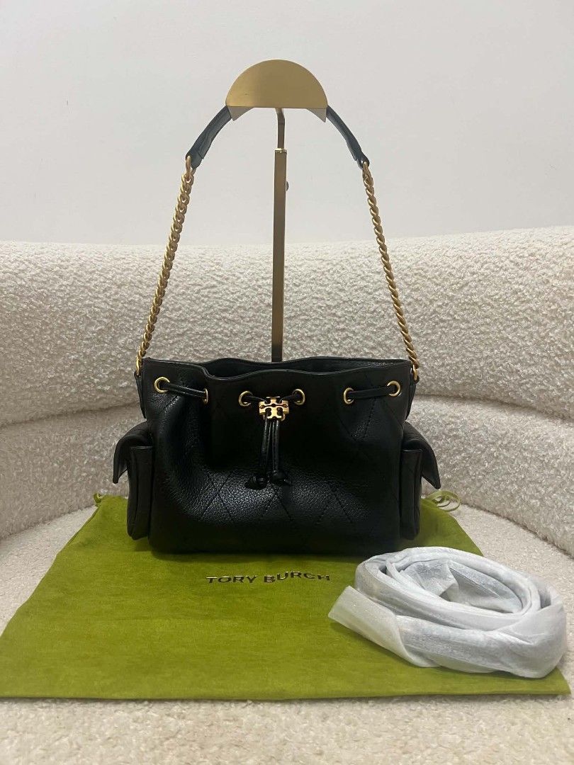 Tory Burch Mini Charlie Drawstring Bag (Category: Shoulder Bags) located in Paoay. Submitted by rvf1230 (Listing ID 1469689344, Image 1). Description: - Brand: Tory Burch - Color: Classic black leather with gold-tone hardware - Design: Quilted diamond pattern on lower half and iconic T logo drawstring closure - Condition: Extremely clean inside and out - Interior: Soft tan suede lining with a secure zippered pocket - Exterior: Handy side pockets 