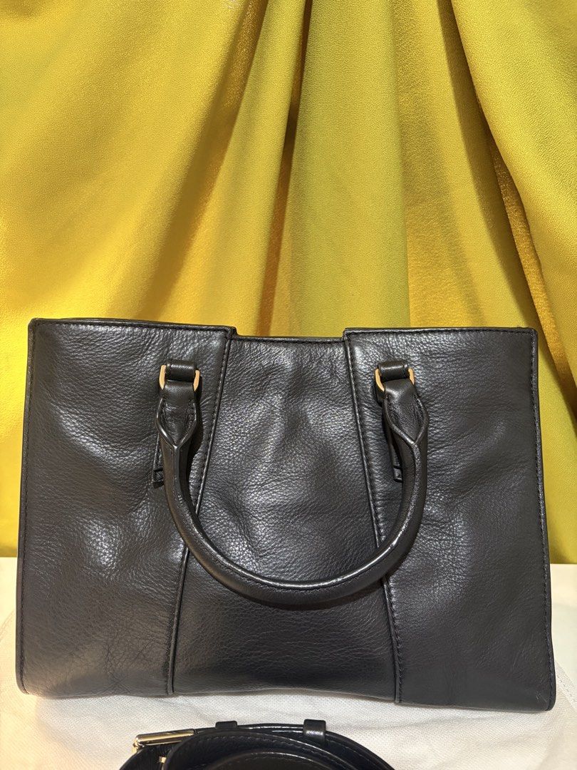 Tory Burch Mini Robinson (Category: Tote Bags) located in Borongan. Submitted by charmspreloveddd (Listing ID 1469596298, Image 2). Description: - Authentic Tory Burch black pebbled leather tote bag - Elegant gold-tone hardware throughout - Dual top handles plus a detachable shoulder strap with chic chain links - Organized interior with a secure center zip compartment and side slip pockets - Features signature logo-printed fabric lining.