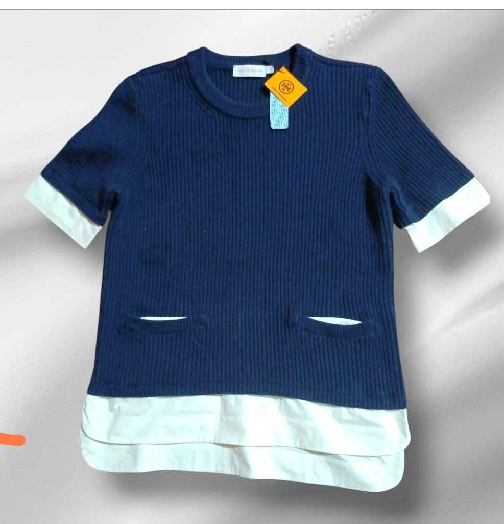 Tory Burch Navy Blue Layered Knit Top Size M (Category: Longsleeves) located in Paranaque City. Submitted by calm_youngstore7 (Listing ID 1469574051, Image 3). Description: - Brand: Tory Burch - Style: Layered knit top with white contrast cuffs and hem - Color: Navy blue - Size: Medium (M) - Condition: Brand new with original store tags attached - Details: Short sleeves, ribbed texture, crew neck, front patch pockets - Measurements: Width 18 inch