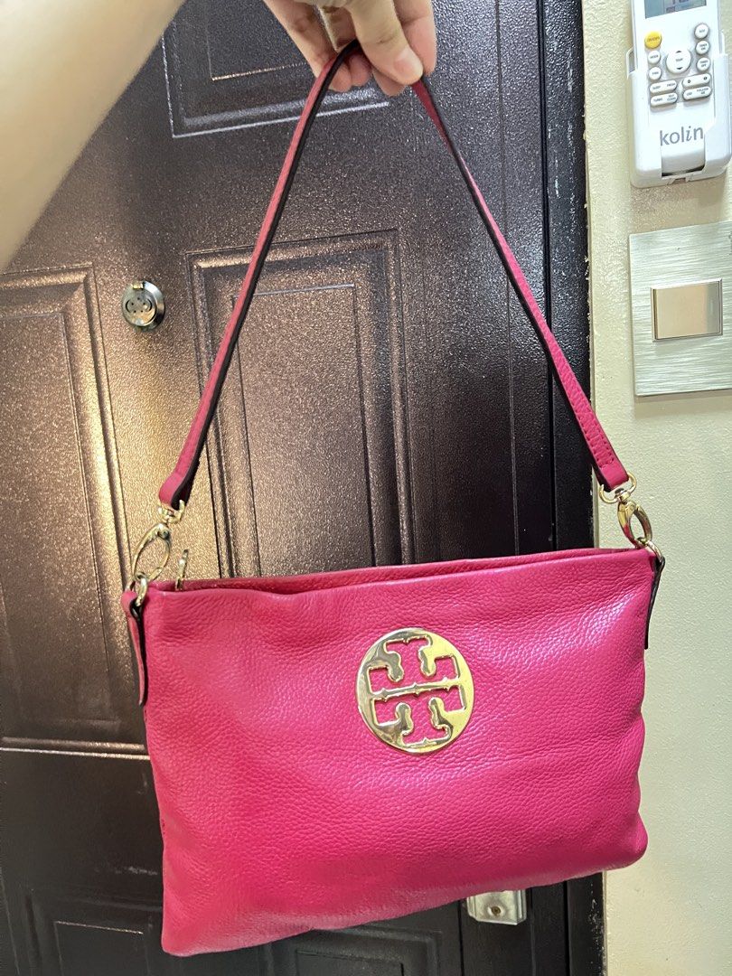 Tory Burch Pink Kili Bag (Category: Luxury Bags & Wallets) located in Manila. Submitted by colineb (Listing ID 1469669269, Image 2). Description: - Brand: Tory Burch - Color: Vibrant pink with polished gold hardware - Exterior: Large front logo emblem and convenient back zip pocket - Interior: Patterned fabric lining with a pink leather brand tag and zip pocket - Strap: Shoulder strap secured with polished gold clasps - Condition: Clean overall c