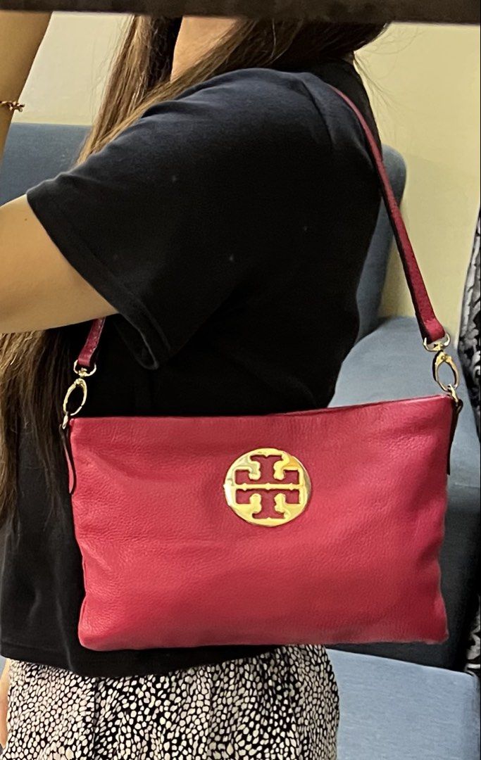 Tory Burch Pink Kili Bag (Category: Luxury Bags & Wallets) located in Manila. Submitted by colineb (Listing ID 1469669269, Image 1). Description: - Brand: Tory Burch - Color: Vibrant pink with polished gold hardware - Exterior: Large front logo emblem and convenient back zip pocket - Interior: Patterned fabric lining with a pink leather brand tag and zip pocket - Strap: Shoulder strap secured with polished gold clasps - Condition: Clean overall c