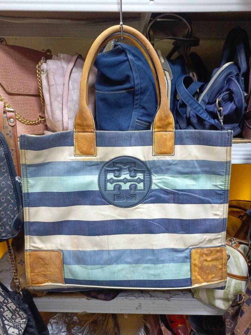 Tory Burch Striped Canvas Tote Bag (Category: Tote Bags) located in Manila. Submitted by dei03_diz (Listing ID 1469641648, Image 1). Description: - Brand: Tory Burch - Style: Canvas Tote Bag - Color/Pattern: Blue, white, and green stripes with brown leather trim - Features: Iconic embossed front logo, double leather handles, secure zip closure with branded pull, and blue fabric interior lining - Condition: Pre-loved, showing noticeable wear on th