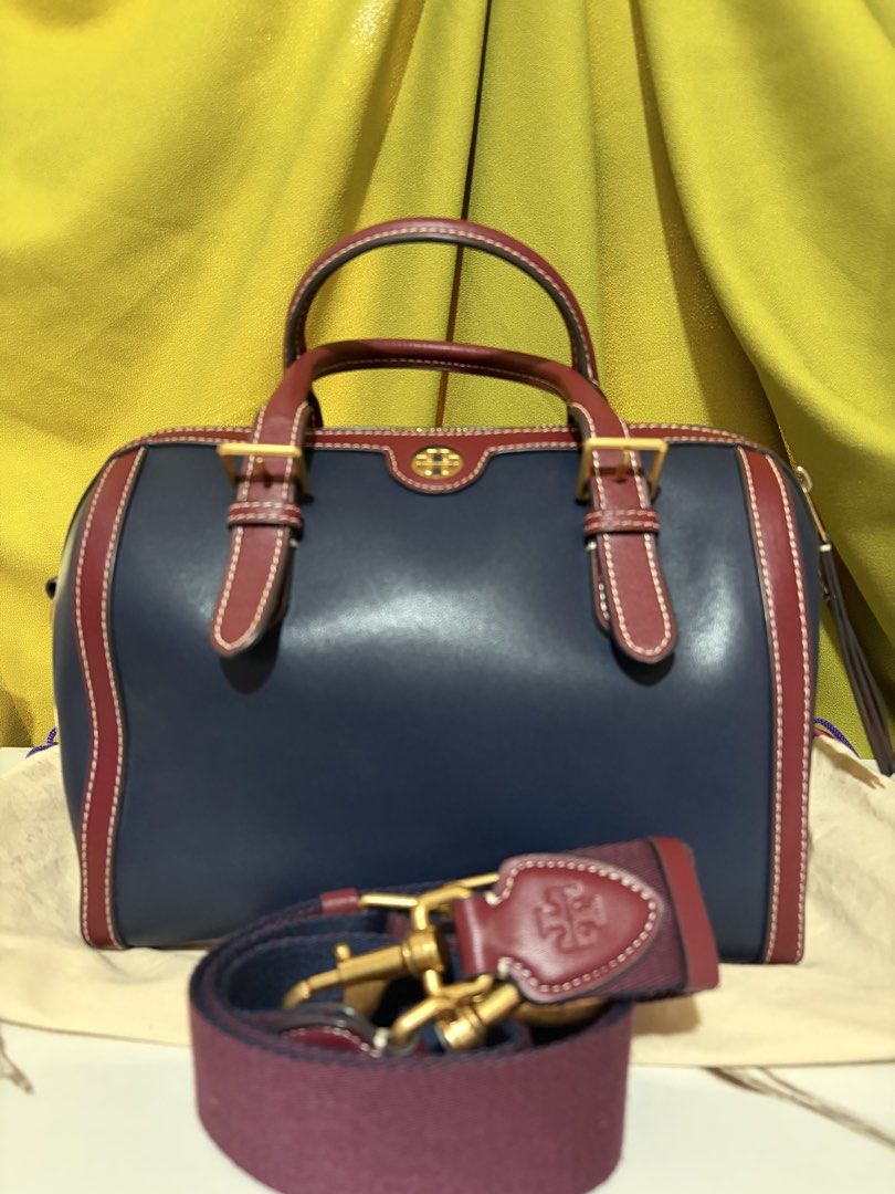 Tory Burch T Monogram Color-Block Barrel Duffle (Category: Luxury Bags & Wallets) located in Borongan. Submitted by charmspreloveddd (Listing ID 1469636844, Image 2). Description: Tory Burch T Monogram Color-Block Barrel Duffle / Mini Boston Bag - Gold tone hardware and logo medallion upfront. - Double top handles plus an adjustable fabric shoulder strap included. - Zip top closure. Clean interior lining with slip and zip pockets. - Dust bag incl