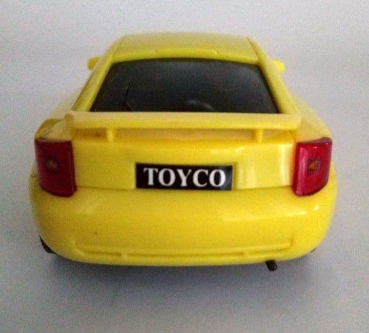 Toyco Yellow Toy Car Model (Category: Vehicle & Diecast Models) located in Tarlac. Submitted by kaizer_shaunne (Listing ID 1469618764, Image 2). Description: - Brand: Toyco - Color: Bright yellow - Features: Rear spoiler and black tinted windows - Details: Molded headlights, tail lights, and clear license plate branding - Wheels: Silver hubcaps on all four wheels - Material: Durable solid plastic construction throughout.