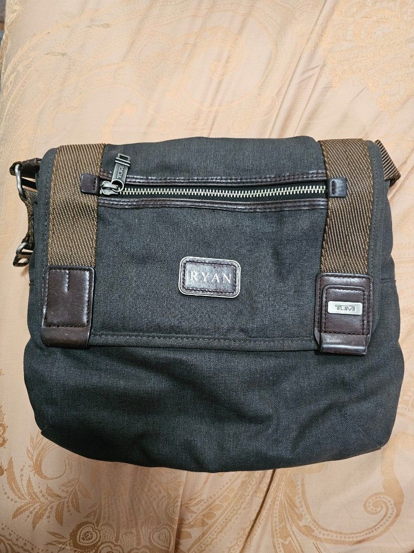 Tumi Crossbody Messenger Bag Dark Grey (Category: Sling Bags) located in Quezon City. Submitted by ryanstuff.ph (Listing ID 1469580569, Image 1). Description: - Brand: Tumi with engraving but can easily be change sa tumi store - Color: Dark grey canvas with brown leather accents and strap - Closure: Flap cover with secure magnetic closure - Hardware: Metal zippers with signature Tumi pulls - Interior: Stylish hexagonal pattern lining with spaciou