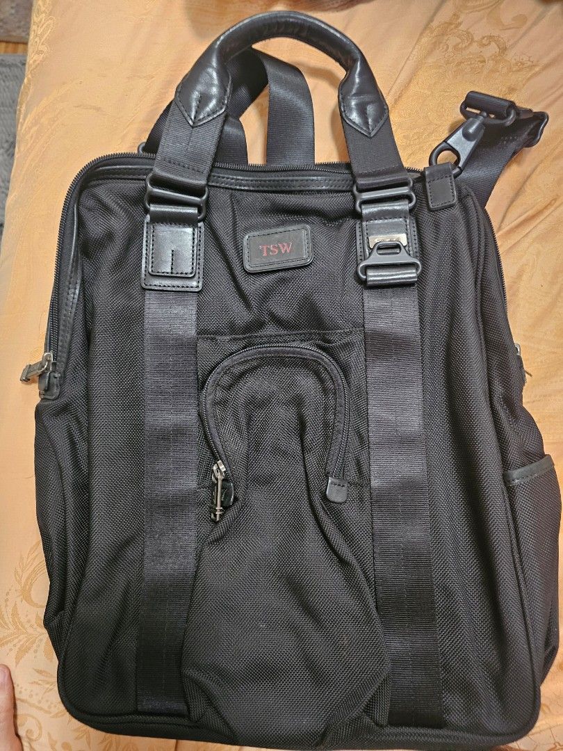 TUMI TSW Black Nylon shoulder Bag with Shoulder Strap (Category: Briefcases) located in Quezon City. Submitted by ryanstuff.ph (Listing ID 1469580413, Image 1). Description: - Material: Durable black ballistic nylon - Compartments: Generous main compartment for daily work essentials and exterior zipped pocket - Carrying Options: Sturdy top handle and adjustable shoulder strap with clips - Hardware: Solid hardware details with secure zip closures 
