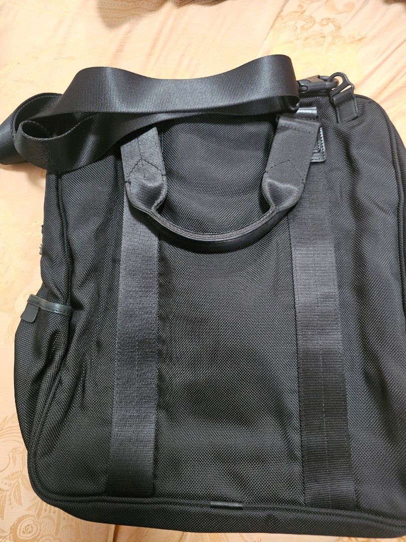 TUMI TSW Black Nylon shoulder Bag with Shoulder Strap (Category: Briefcases) located in Quezon City. Submitted by ryanstuff.ph (Listing ID 1469580413, Image 3). Description: - Material: Durable black ballistic nylon - Compartments: Generous main compartment for daily work essentials and exterior zipped pocket - Carrying Options: Sturdy top handle and adjustable shoulder strap with clips - Hardware: Solid hardware details with secure zip closures 