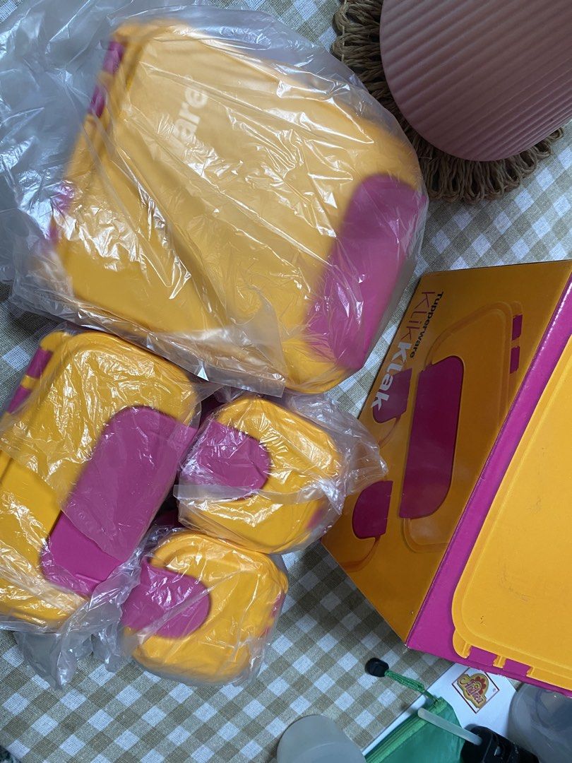 Tupperware KlikKlak Lunch Box Set-4 pcs (Category: Food Organization & Storage) located in Cavite. Submitted by yc.shoppemnl (Listing ID 1469577761, Image 3). Description: - Authentic Tupperware KlikKlak food storage set - Colors: Vibrant yellow and pink - Brand new, never used, and individually wrapped in original retail box - 1x large compartment container with a divider - 1x medium container - 2x small snack boxes - Ideal for meal prep, office