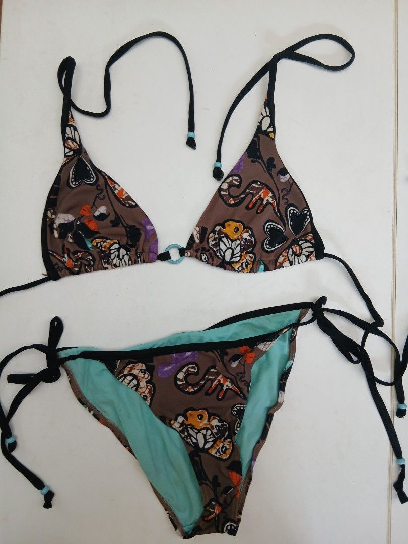 Two-Piece Bikini Swimsuit Brown Multi-Print (Category: Bikinis & Swimsuits) located in Cainta. Submitted by chickennuggirl (Listing ID 1469579639, Image 1). Description: - Style: Two-piece bikini set - Color/Pattern: Brown with colorful abstract floral and creature prints - Top: Triangle cut with a small light blue ring connector and adjustable string ties with beaded accents - Bottoms: Side-tie style with a bright turquoise inner lining - Condit