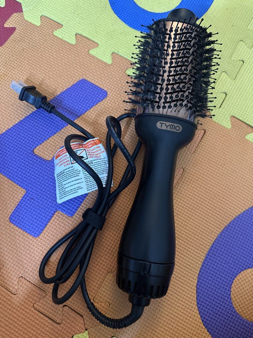 TYMO Volumizer Hair Dryer Brush (Category: Hair) located in Manila. Submitted by diorsnowsantos (Listing ID 1469635830, Image 1). Description: - Authentic TYMO blow dryer brush in elegant black and rose gold - Round bristle design for simultaneous drying and styling - Good working condition, well-maintained - Standard two-prong electrical plug - Original warning tag still attached to the cord - Perfect for quick and easy salon-like blowouts at ho