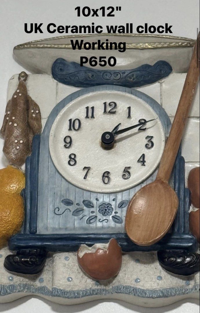 UK Ceramic wall clock 10x12 Working (Category: Clocks) located in Cainta. Submitted by elainelawenko (Listing ID 1469735356, Image 1). Description: - Design: Kitchen scale wall clock with cute molded details (wooden spoon, lemons, and eggshell) - Color & Material: Blue and white ceramic - Size: 10 x 12 inches - Mechanism: Fully working battery-operated analog clock face with clear 1-12 numbers - Perfect for: Kitchen walls, cafes, or bakery decor.