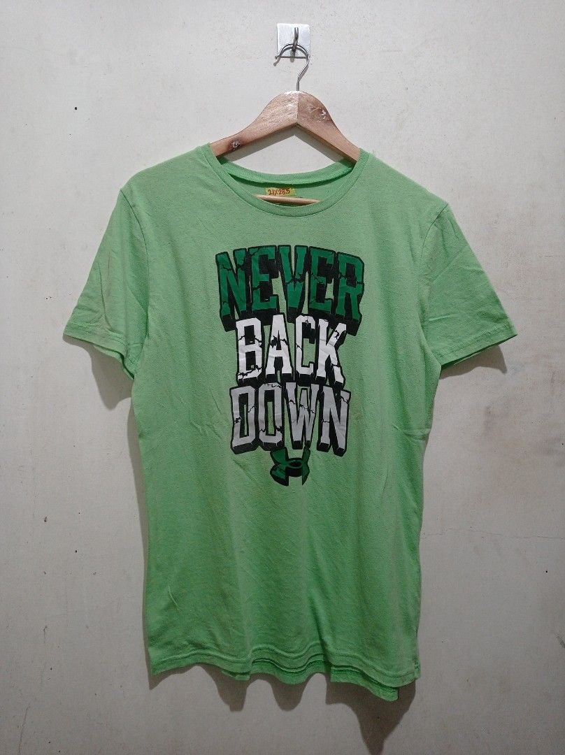 Under Armour "never back down" (Category: Tshirts & Polo Shirts ) located in Pasig City. Submitted by pureselectionapparel (Listing ID 1469748921, Image 1). Description: Under Armour "never back down" 🏷️ Size med-large Dimes: 21width 28.5length Very Good Condition Issue: Fine lints 300 plus ship Location: Pasig City.