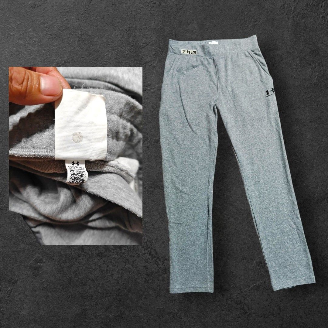 Underarmour jogging pants (Category: Other Bottoms) located in Rizal. Submitted by itsmecle0 (Listing ID 1469647204, Image 1). Description: The image displays a pair of light gray straight-leg athletic sweatpants featuring the Under Armour logo printed on the left thigh. Designed with an elastic waistband, side slit pockets, and open open-bottom hems, they offer a comfortable and relaxed fit ideal for lounging or light workouts..
