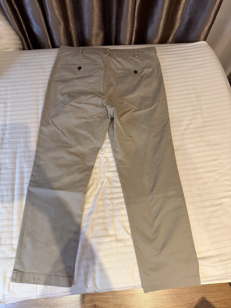 Uniqlo Grey Chino Pants (Category: Chinos) located in Muntinlupa City. Submitted by golf823 (Listing ID 1469684401, Image 2). Description: - Brand: Uniqlo - Color: Khaki grey - Size: 79cm waist - Material: 97% cotton, 3% spandex (with stretch for comfort) - Features: Zip fly, back button pockets - Condition/Fit: Measurements available in photos.