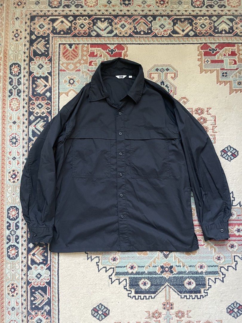 Uniqlo U Work Shirt (Category: Sets & Coordinates) located in Pasig City. Submitted by erzvgo (Listing ID 1469635755, Image 1). Description: Uniqlo U black long-sleeve work shirt Size large, relaxed fit Excellent condition Two utility chest pockets with horizontal seam detailing across the front and back. Classic pointed collar, button closure down the front, and single-button cuffs. Buyer handles delivery from Makati.