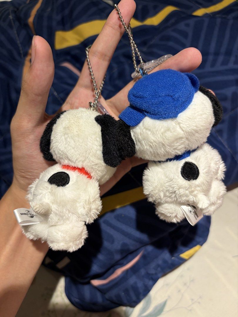 USJ Snoopy and Spike plush keychains (Category: Plushies & Soft Toys) located in Makati City. Submitted by squishycorner (Listing ID 1469714406, Image 2). Description: - Authentic merchandise from Universal Studios Japan (USJ) - Set includes 2 plush keychains: Regular Snoopy (red collar) and Spike (blue hat & collar) - Features white fur and iconic black ears - Complete with original ball chain attachments and USJ tag on the back - Condition: Cle