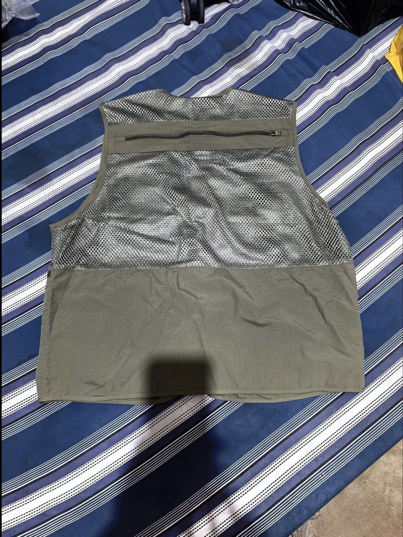 utility vest / net vest (Category: Vests) located in Makati City. Submitted by tanenya10478407 (Listing ID 1469712385, Image 2). Description: - Brand/Model: Outdoor Utility Vest - Size: L-XL - Color: Olive green with breathable mesh upper - Pockets: Multiple multi-functional zipper and velcro pockets on front and back - Hardware: Heavy-duty zippers throughout - Best for: Outdoor activities, hiking, or streetwear layering -used once -unisex -no da