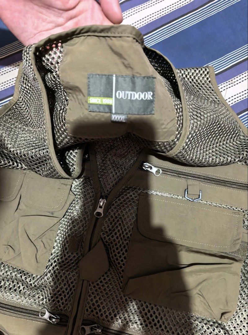 utility vest / net vest (Category: Vests) located in Makati City. Submitted by tanenya10478407 (Listing ID 1469712385, Image 3). Description: - Brand/Model: Outdoor Utility Vest - Size: L-XL - Color: Olive green with breathable mesh upper - Pockets: Multiple multi-functional zipper and velcro pockets on front and back - Hardware: Heavy-duty zippers throughout - Best for: Outdoor activities, hiking, or streetwear layering -used once -unisex -no da