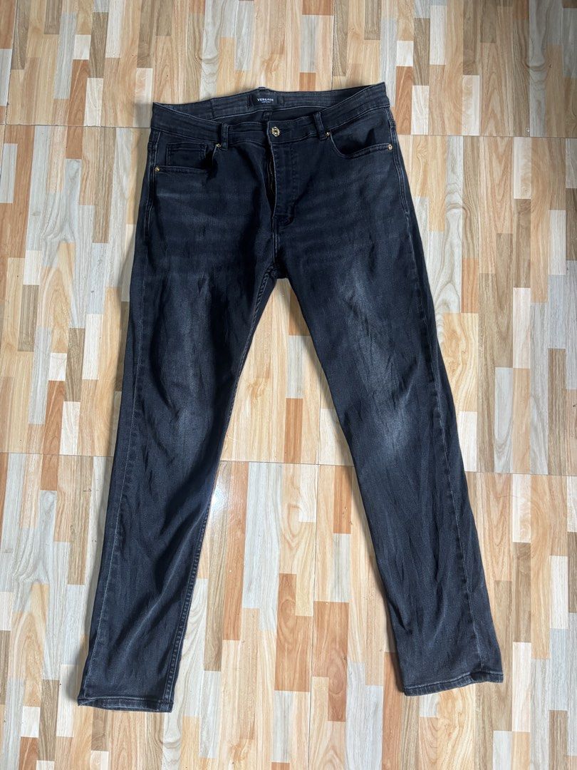 Versace Black Denim Jeans Size 34 (Category: Jeans) located in Tubigon. Submitted by wawiesunbe75372 (Listing ID 1469640056, Image 3). Description: - Brand: Versace - Size: 34 - Color: Washed black - Fit: Regular fit denim - Details: Embroidered Versace branding on the back pocket, branded hardware, button closure, and leather logo patch at the back waistband - Origin: Made in Italy - Condition: Excellent / Ready to wear.