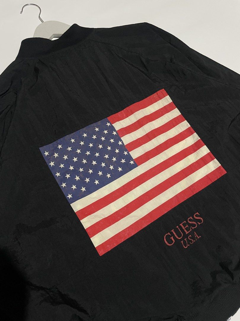 Vintage guess American flag bomber jacket (Category: Coats, Jackets and Outerwear) located in Bais. Submitted by christian.complexthrift08 (Listing ID 1469743347, Image 3). Description: Vintage Guess “American flag” bomber jacket (Massive American flag at the back) Color: black Size: XL boxy fit Width: 26.5 inches Length: 26.5 inches Condition: 9 / 10 Issue: -barely noticeable stain in the inside liner -print issue at the back but it is still ver