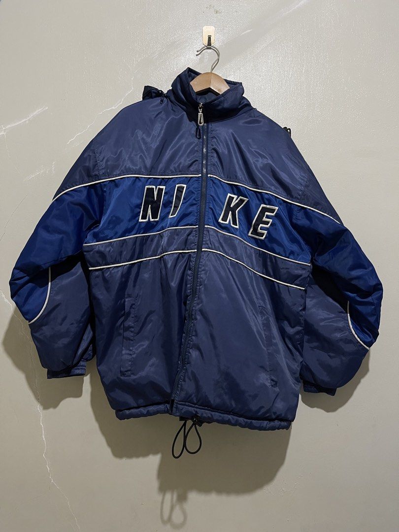 Vintage Nike ACG Blue Puffer Hooded Jacket (Category: Coats, Jackets and Outerwear) located in Manila. Submitted by micoletszx81430 (Listing ID 1469678521, Image 1). Description: - Vintage 90s Nike ACG puffer jacket - Color: Dark blue with bold white chest lettering - Embroidered ACG triangle logo and swoosh on the back - Full zip closure with adjustable hood and bottom cinch cord - Super warm, thick outdoor gear - Made in Sri Lanka.