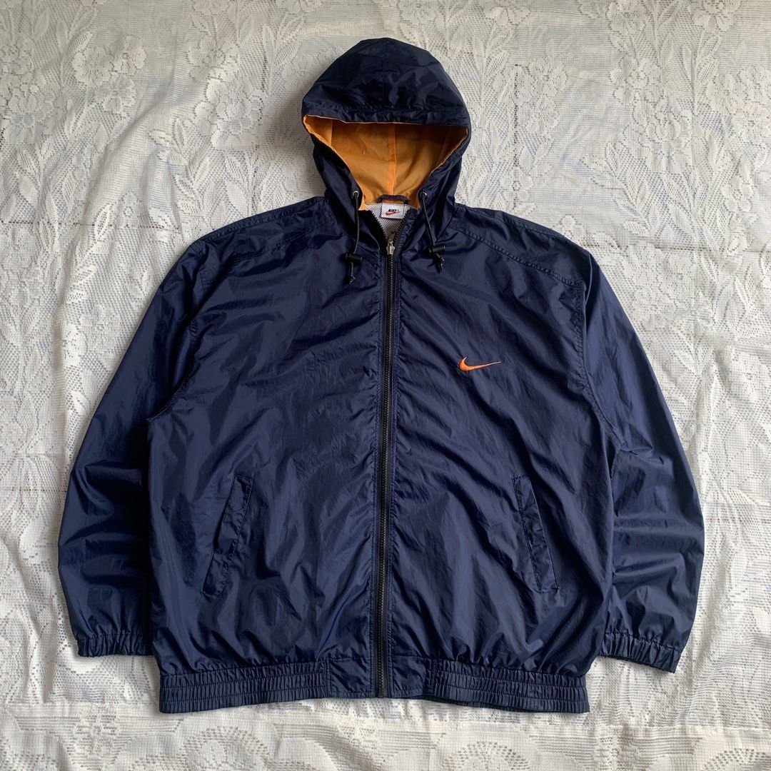 Vintage Nike Navy Blue Orange Windbreaker Jacket (Category: Coats, Jackets and Outerwear) located in Manila. Submitted by xumiiyea (Listing ID 1469583797, Image 1). Description: Nike 1990s vintage retro sportswear windbreaker navy blue size large 100% nylon made in Indonesia Full zip dual front pockets adjustable drawstring hood Excellent vintage condition.